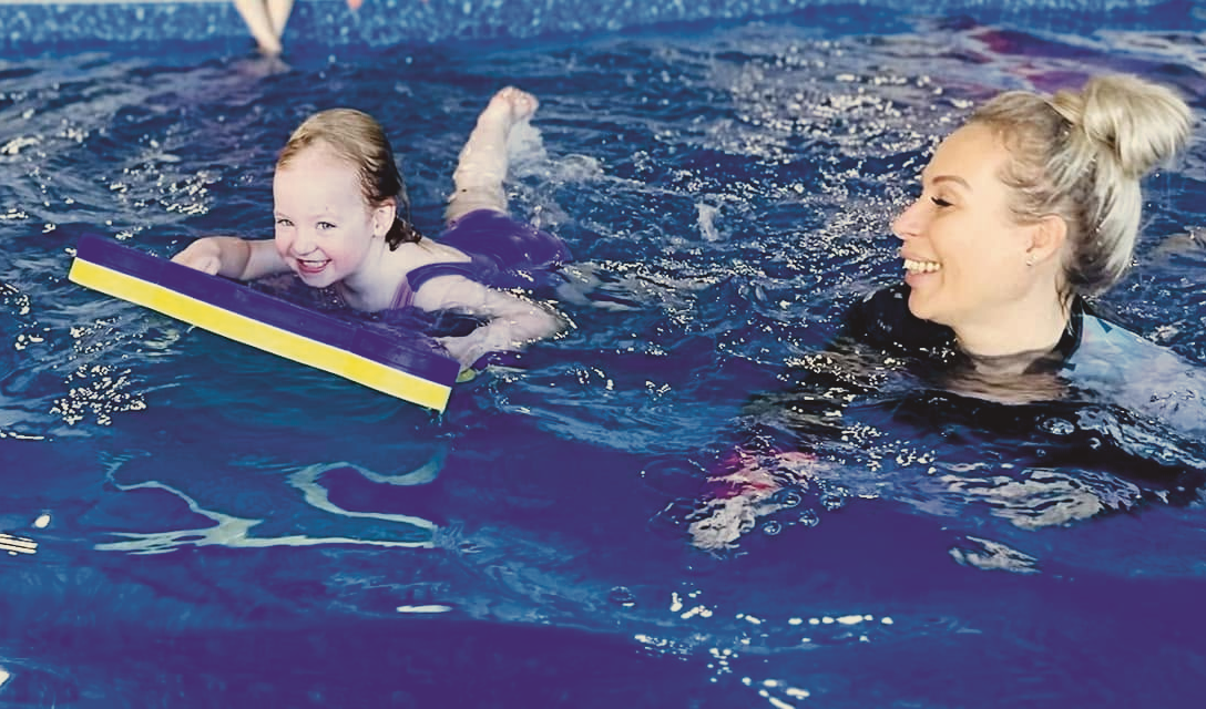 Preschool child learning to swim