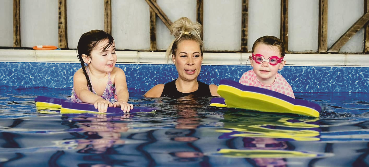 Happy child splashing in the pool